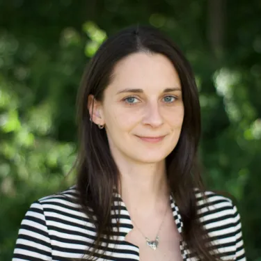 profile picture of woman in black and white striped shirt.